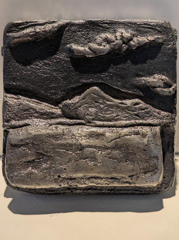 cast iron sculpture of low relief landscape