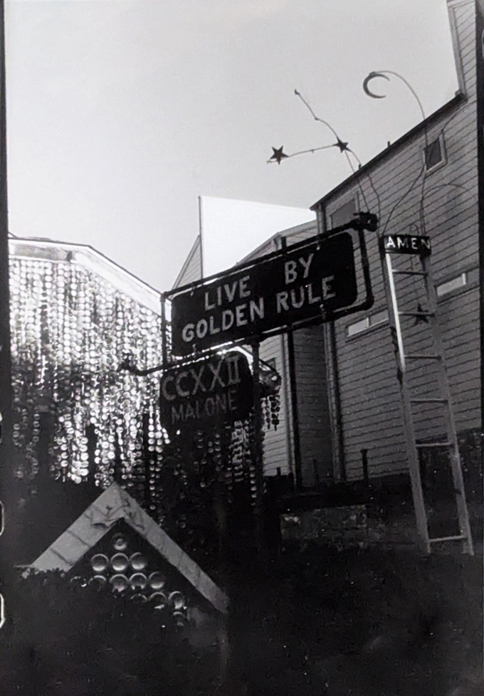 b/w photo of signs "Live by golden rule, CCSSII Malone, Amen"
