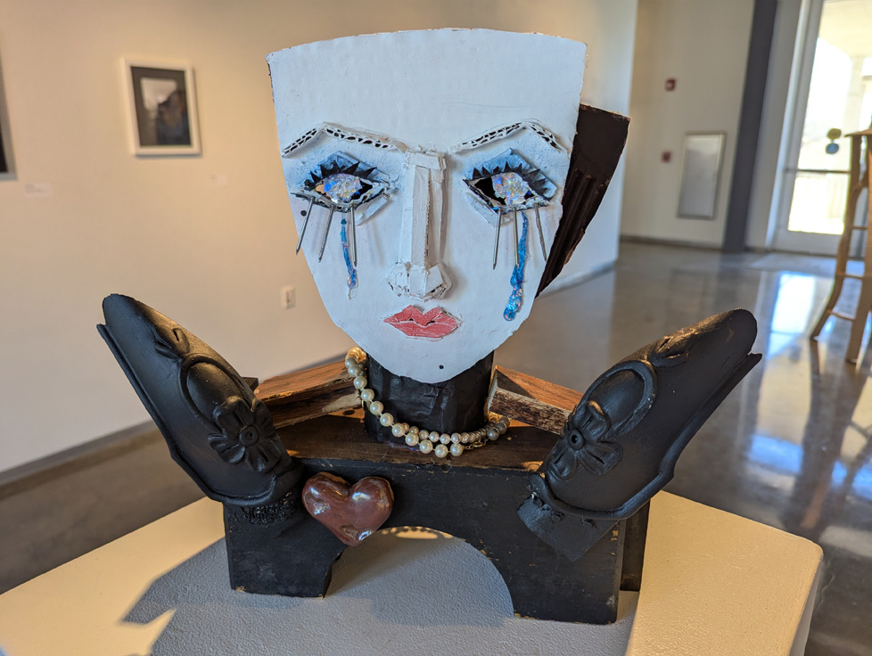 found-object sculpture of woman's face, crying