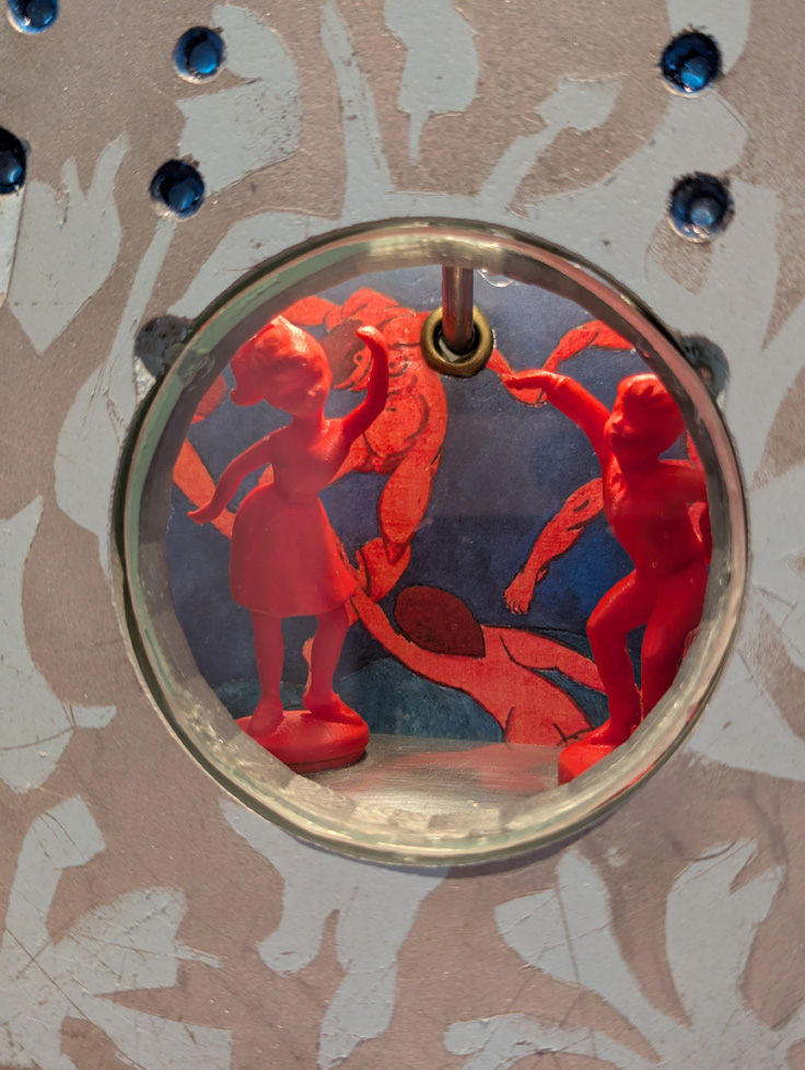 iron detail - 3D printed dancers in red seen through window