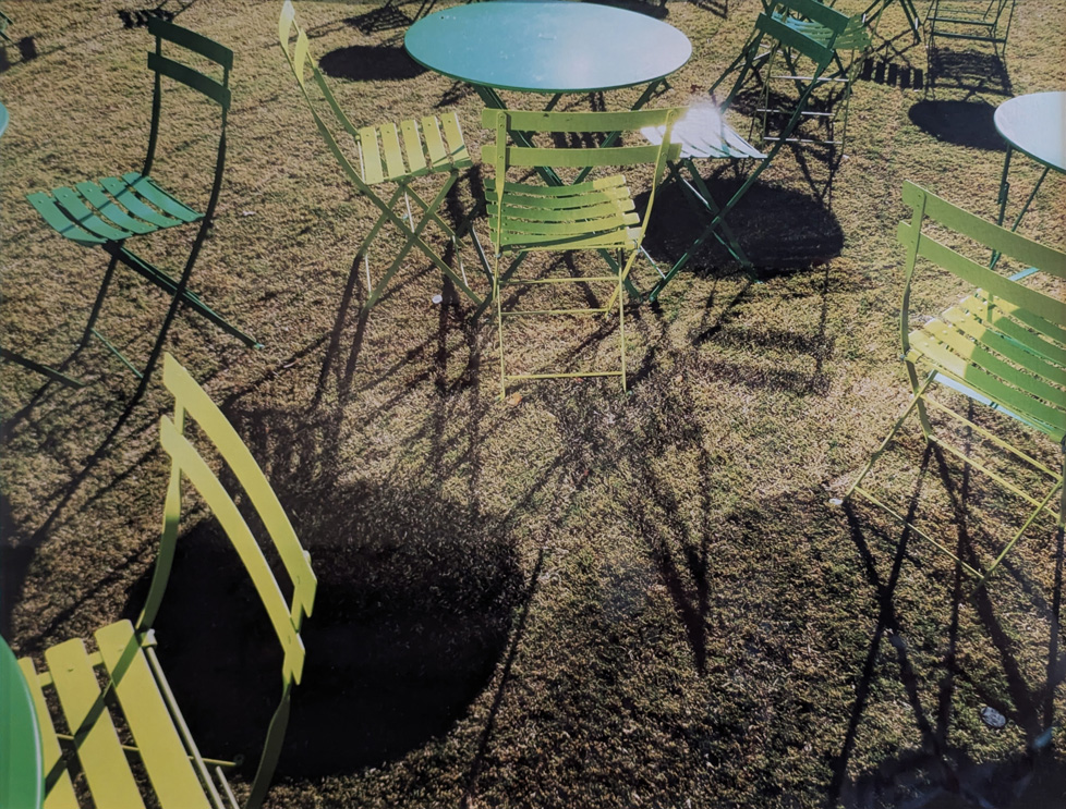 photo of outdoor furniture, green folding chairs, round tables