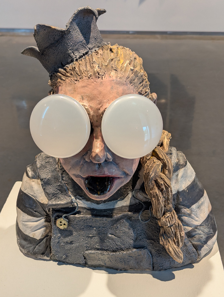 detail of self-portrait bust, light bulb eyes