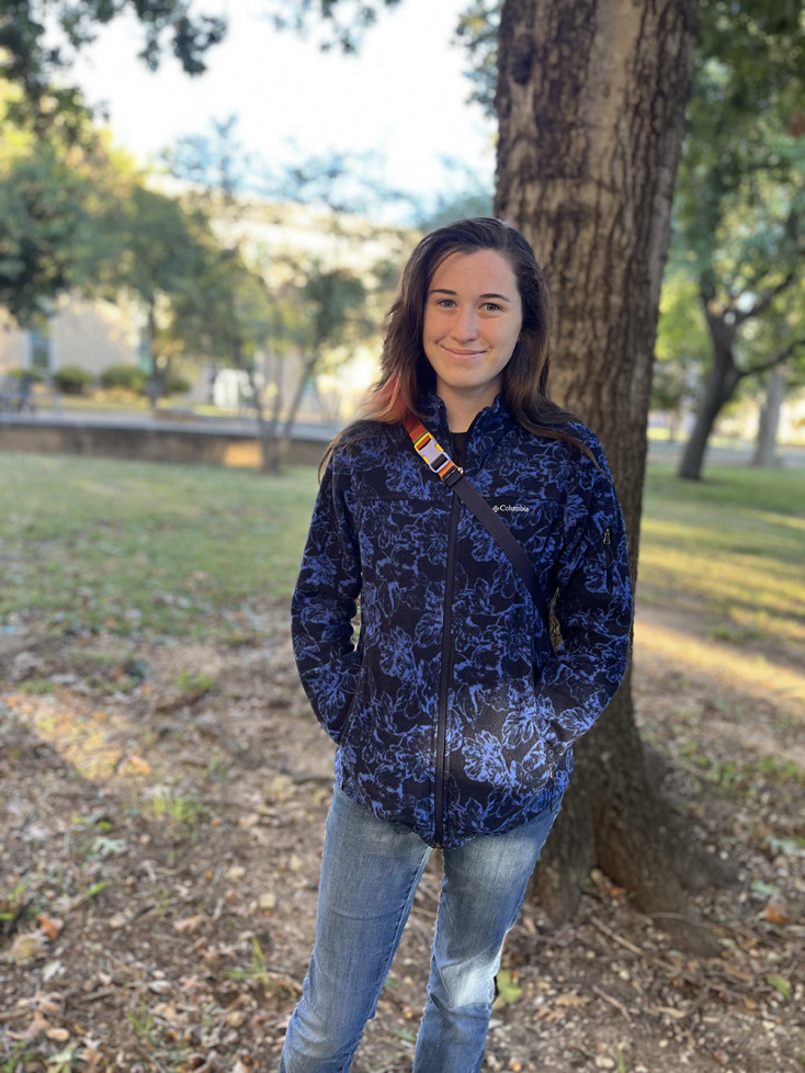 Ashlyn on campus by a tree