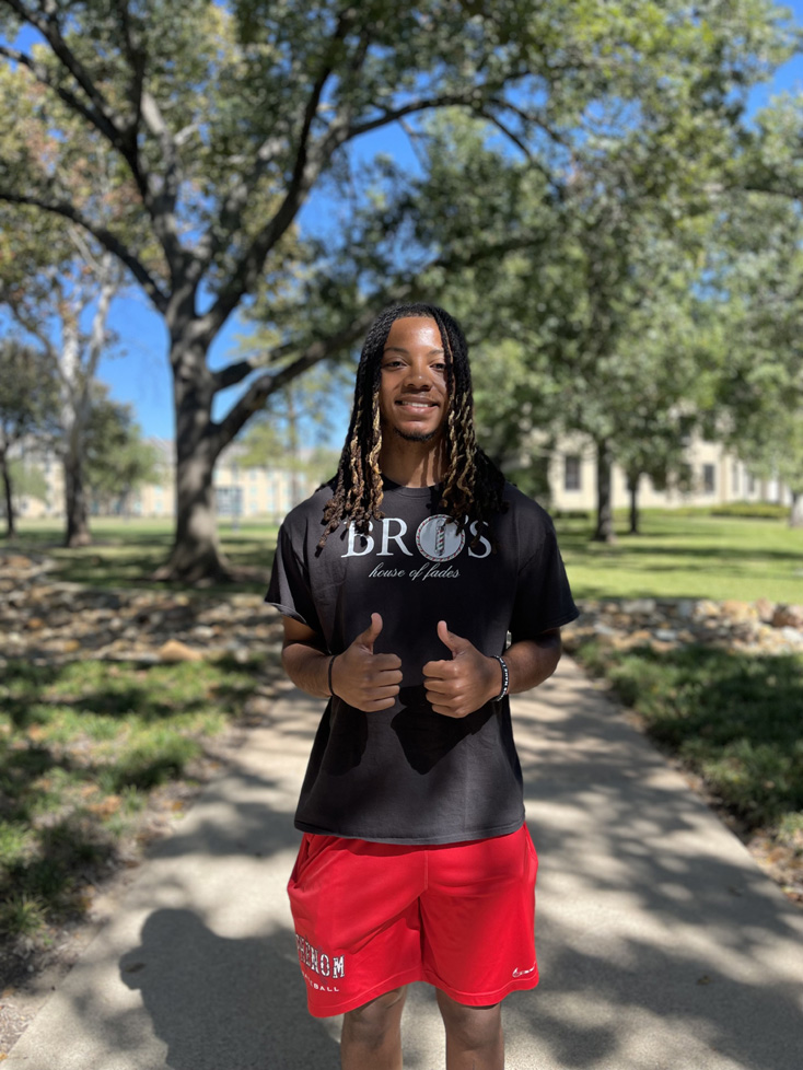 Caleb in red shorts, thumbs up on the Mall