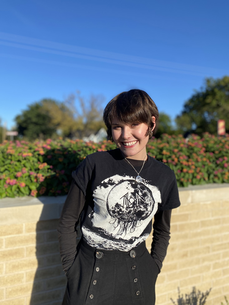 Caryss with short crop and bangs by flower bed