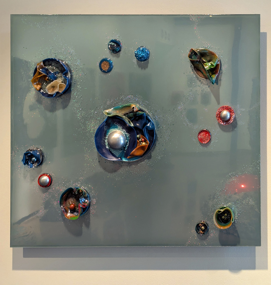 one silver square with several round, colorful protrusions