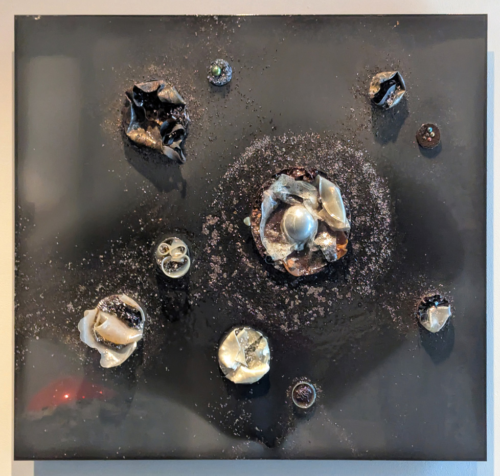 dark gray square with silvery protrusions