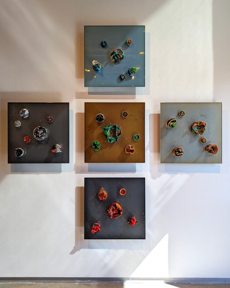 set of 5 squares, each with a different color scheme, forming a cross, 